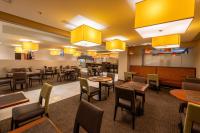 a restaurant with tables and chairs and yellow lights at MARINN PLACE Financial District in Panama City