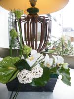 a vase with white flowers on a table at Hôtel de L&#39;Avenue in Saintes