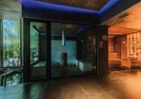 a room with large glass windows in a building at Stay Wellbeing & Lifestyle Resort in Rawai Beach