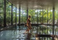 a woman in a swimming pool with a hose at Stay Wellbeing & Lifestyle Resort in Rawai Beach