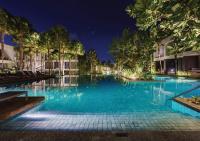 a swimming pool with blue water at night at Stay Wellbeing & Lifestyle Resort in Rawai Beach