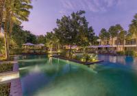 a swimming pool at a resort with blue water at Stay Wellbeing & Lifestyle Resort in Rawai Beach
