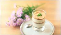 a dessert in a glass on a plate with flowers at Errantry Lodge &amp; Studio in Hualien City
