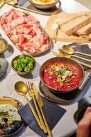 una mesa cubierta con tazones y platos de comida en Hotel Petit Bois - Adults from 14, en Balatonfüred