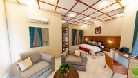 a hotel room with a bed and a living room at Serengeti legacy Lodge in Lukungu