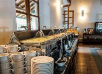 a buffet line with plates and cups and dishes at Rest House Matara in Matara