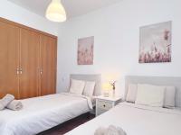 A bed or beds in a room at A Levante Conil- Solo familias y parejas