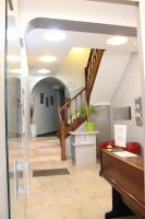 a hallway with a staircase in a building at Hôtel De Normandie in Amiens