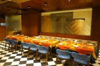 un comedor con mesas y sillas y una gran pintura en The Sky Imperial Hotel Sugam - 10 Meters from Shrinathji Temple, en Nathdwara