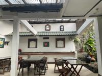 a patio with tables and chairs and a building at Happy Valley - GG House in Gadok 1