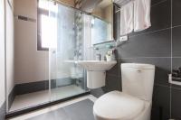 a bathroom with a toilet and a sink and a shower at Valley Silence B&amp;B in Ji&#39;an