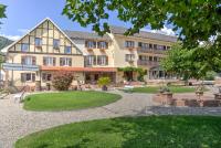 a large building with a park in front of it at Parc Hôtel in Wangenbourg