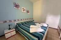 Posteľ alebo postele v izbe v ubytovaní Residenza Pierre & Vacances Luni Mare
