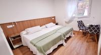 Posteľ alebo postele v izbe v ubytovaní Hostal Cachiño
