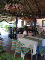 a dining room with tables and chairs and flowers at Hotel Doña Edita in San Bernardo del Viento