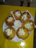 a plate of muffins with cheese on a yellow table at Hotel Doña Edita in San Bernardo del Viento