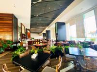 a dining room with tables and chairs and a restaurant at Arterra Seaview Resort in Mactan