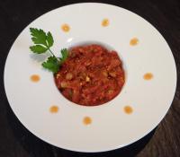 a plate with a bowl of salsa on a table at Les Terrasses - Gordes in Gordes