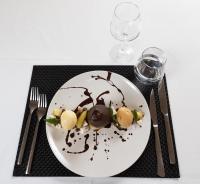 a plate of food with chocolate on a table at Auberge Les Grillons in Meyras