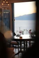 a dining room table with a view of a window at Fuxian Lake Three Thousand French Manor Hotel in Xujiadu