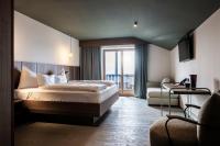 A bed or beds in a room at Hotel Belvedere - Fine Dining, Hideaway & SPA