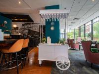 a bar with a white cart in a restaurant at Novotel London West in London