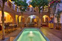 a house with a pool in the middle of a building at Riad Fleur d&#39;Orient in Marrakech