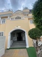 a large yellow building with a door and stairs at Presken Hotel OPEBI Branch in Lagos