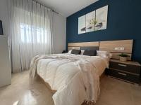 A bed or beds in a room at Arenal Golf Apartment
