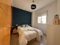 A bed or beds in a room at Arenal Golf Apartment
