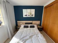 A bed or beds in a room at Arenal Golf Apartment