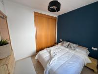 A bed or beds in a room at Arenal Golf Apartment