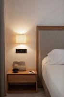 a bedroom with a bed and a table with a lamp at Can Jaume by Ocean Drive in Ibiza Town