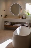 a bathroom with a white tub and a mirror at Can Jaume by Ocean Drive in Ibiza Town