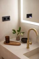 a bathroom sink with a vase of flowers on it at Can Jaume by Ocean Drive in Ibiza Town
