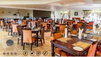 a dining room filled with tables and chairs at Dans Country Lodge in Mthatha