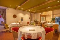 a restaurant with tables and chairs with white table cloth at Zoetry Mallorca Wellness & Spa in Llucmajor