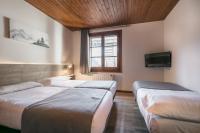 Postel nebo postele na pokoji v ubytování Hotel SNÖ Mont Romies