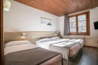 Postel nebo postele na pokoji v ubytování Hotel SNÖ Mont Romies