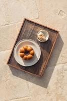a plate with a donut on a wooden tray at Casale Oleo in Montiano