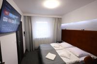 Łóżko lub łóżka w pokoju w obiekcie Hotel Junior