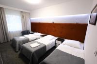 Łóżko lub łóżka w pokoju w obiekcie Hotel Junior