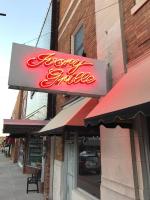 a sign for a restaurant on the side of a building at Hotel Bothwell Sedalia Central District, an Ascend Collection Hotel in Sedalia
