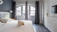 Łóżko lub łóżka w pokoju w obiekcie L'Escapade Urbaine - Cosy et central