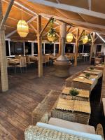 a restaurant with tables and chairs and chandeliers at Tanger Miramonte - Resort Suites & Double Rooms in Tangier