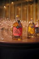 two bottles of alcohol on a table with wine glasses at De Pingerhoeve in Nuth