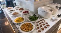 a buffet with plates of food on a counter at Forward Hotel Taipei Nangang in Taipei