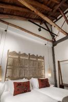A bed or beds in a room at Hotel La Casa de Los Mosaicos