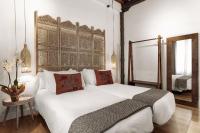 A bed or beds in a room at Hotel La Casa de Los Mosaicos