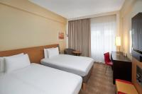 a hotel room with two beds and a television at Novotel London West in London